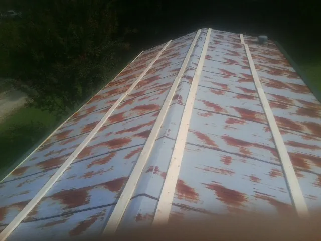Rusted metal roof panels with new wood purlins before replacement — Storm Damage Roof Repair in Long Creek by Roofing Brothers