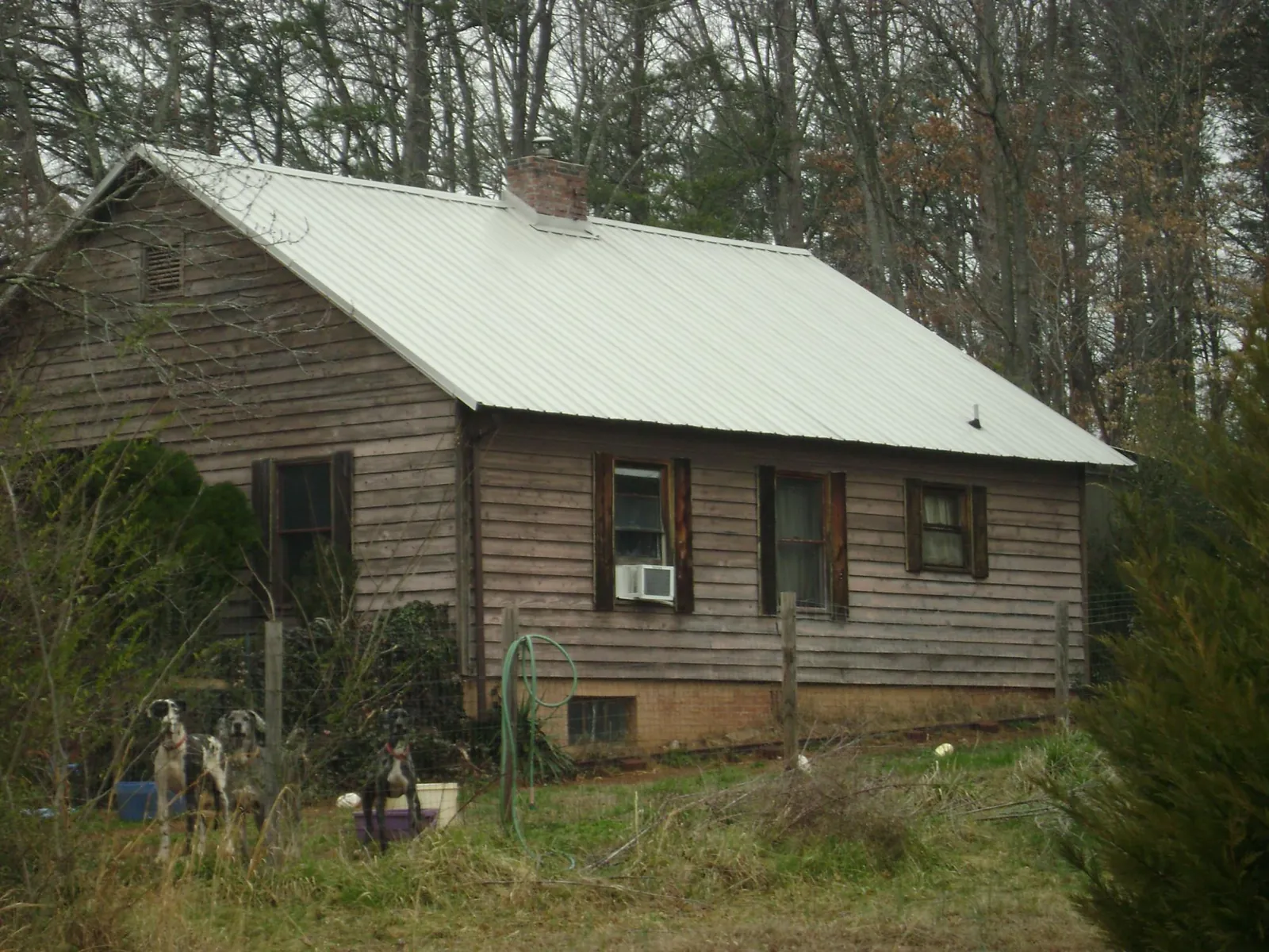 White metal roof on an old wood sided farmhouse, from a Metal Roof Installation job in Long Creek